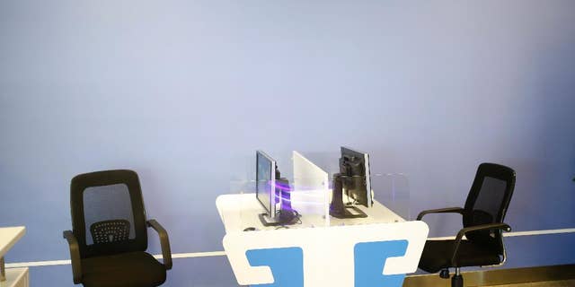 In this Monday, Aug. 24, 2015 photo, computers with no keyboard provided are seen at an Internet corner at the airport in Pyongyang, North Korea. The new airport building has just about everything including the Internet room. The problem is, it doesn't seem to work. (AP Photo/Dita Alangkara)