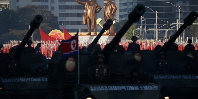 Oct. 10, 2015: Statues of Kim Il Sung and Kim Jong Il stand above soldiers during a military parade in Pyongyang, North Korea. (AP Photo/Wong Maye-E)