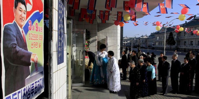 March 9, 2014 - Voters line up to cast their ballots to elect deputies to the 13th Supreme People's Assembly in Pyongyang, North Korea. North Korean voters went to polling stations to elect a new national legislature, although they don't get to choose who to vote for since there is only one candidate per district.