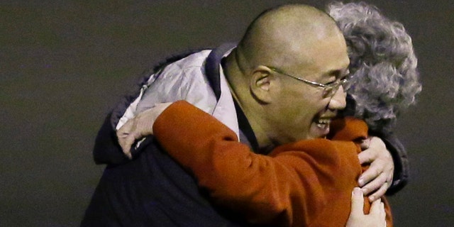 November 8, 2014: Kenneth Bae, left, who had been held in North Korea since 2012, hugs his mother Myunghee Bae after arriving at Joint Base Lewis-McChord, Wash., after being freed during a top-secret mission by James Clapper, U.S. director of national intelligence. (AP Photo/Ted S. Warren)