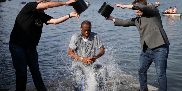 Aug. 31, 2014: Two-time Grammy award winning rapper and a founding member of the Fugees, Pras Michel, gets doused by his friends for the ALS Ice Bucket Challenge in Pyongyang, North Korea. (AP)