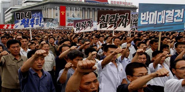 North Koreans march on Kim Il Sung Square in Pyongyang, North Korea as they hold an anti-U.S. demonstration on Tuesday, the 63rd anniversary of the outbreak of the three-year Korean War, from 1950 to 1953.