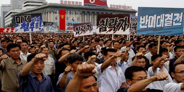 North Koreans march on Kim Il Sung Square in Pyongyang, North Korea as they hold an anti-U.S. demonstration on Tuesday, the 63rd anniversary of the outbreak of the three-year Korean War, from 1950 to 1953.