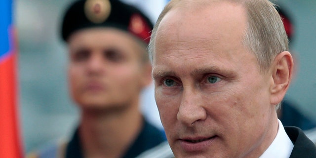 FILE - In this May 9, 2014 file photo, Russian President Vladimir Putin heads to speak at a navy parade marking Victory Day in Sevastopol, Crimea. (AP Photo/Ivan Sekretarev, File)