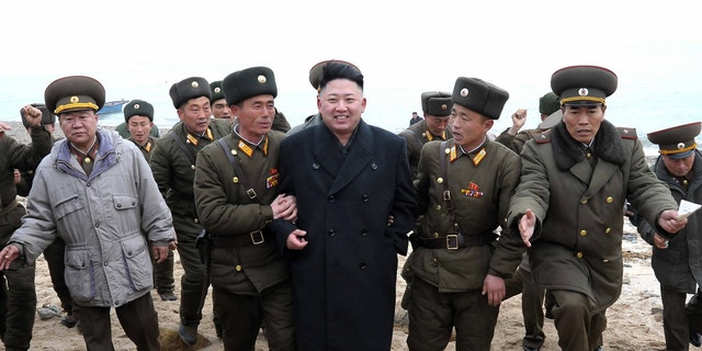March 7, 2013 - North Korean leader Kim Jong Un walks with military personnel as he arrives for a military unit on Mu Islet, in the southernmost part of North Korea's border with South Korea.