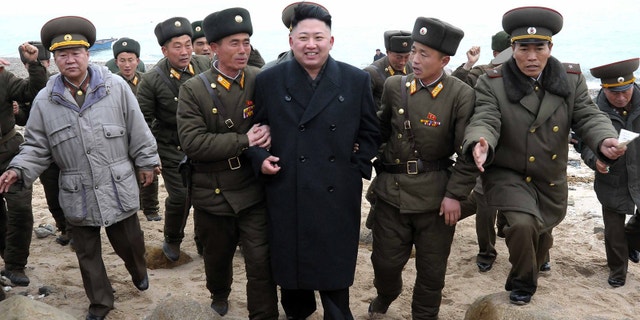 March 7, 2013 - North Korean leader Kim Jong Un walks with military personnel as he arrives for a military unit on Mu Islet, in the southernmost part of North Korea's border with South Korea.
