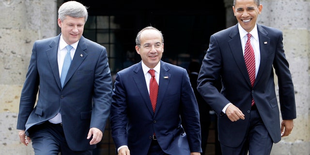 In this Aug. 10, 2009, photo, President Barack Obama, right, Mexico's President Felipe Calderon, center, and Canada's Prime Minister Stephen Harper walk towards a stand for an official photo in Guadalajara, Mexico, for a North American summit. (AP Photo/Alex Brandon, File)