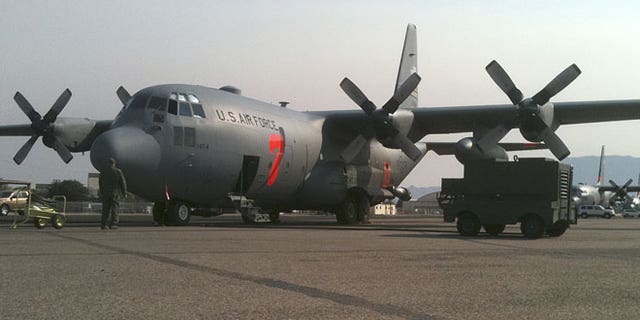 In this July 2, 2011 photo provided by the North Carolina National Guard, a crew prepares a C-130 MAFFS 7 (Modular Airborne FireFighting System) cargo plane to battle a wildfire, in Albuquerque, New Mexico.