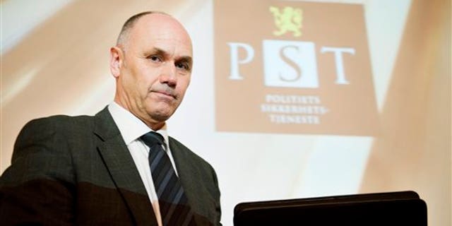 March 16, 2012: A projection causing striation on the face of acting head of Norway's domestic intelligence service PST, Roger Berg, as he faces the media.