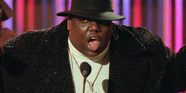Notorious B.I.G., who won rap artist and rap single of the year,   clutches his awards at the podium during the annual Billboard Music Awards in New York, Wednesday evening, Dec. 6, 1995. The awards were upstaged by the absence of Michael Jackson, who had  been scheduled to receive an award but collapsed hours earlier and was taken to a hospital. (AP Photo/Mark Lennihan)