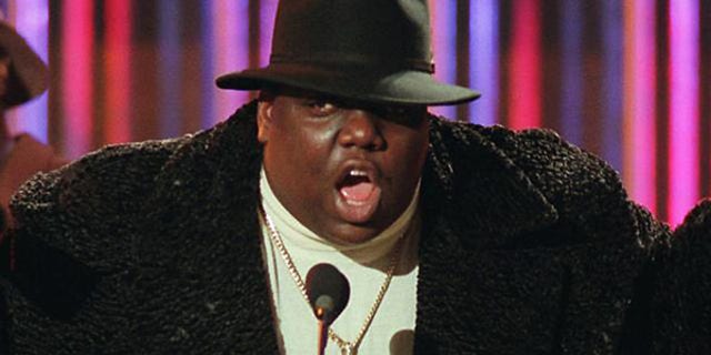 Notorious B.I.G., who won rap artist and rap single of the year, clutches his awards at the podium during the annual Billboard Music Awards in New York, Wednesday evening, Dec. 6, 1995. The awards were upstaged by the absence of Michael Jackson, who had been scheduled to receive an award but collapsed hours earlier and was taken to a hospital. (AP Photo/Mark Lennihan)