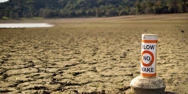 FILE 2014: A buoy meant for boaters rests on the dry bed of Lake Mendocino, a key Mendocino County reservoir, in Ukiah, California.