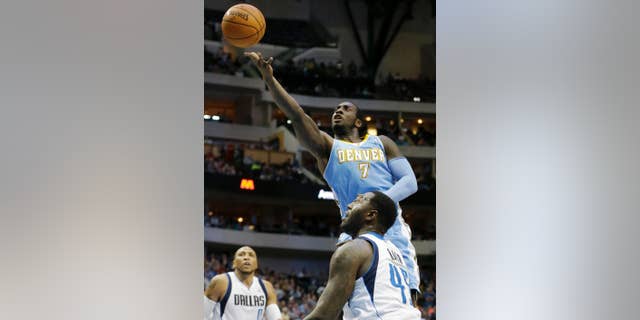 Denver Nuggets center J.J. Hickson (7) shoots against Dallas Mavericks center DeJuan Blair (45) as Shawn Marion (0) looks on during the first half an NBA basketball game Friday, March 21, 2014, in Dallas. (AP Photo/LM Otero)