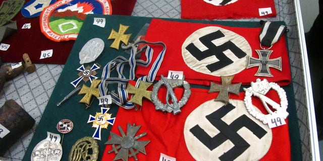 Sept. 19, 2014: This photo shows medals and Nazi armbands at an auction house in Anchorage, Alaska. Those items are among World War II items, including carbon copies of Nuremberg trial transcripts, that are being auctioned off Saturday through the Alaska Auction Co. (AP/Rachel D'Oro)