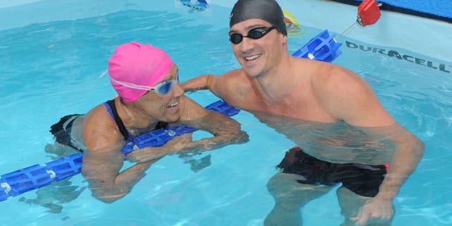 Eleven-time Olympic medalist Ryan Lochte swims with Diana Nyad during her 48-hour continuous "Swim for Relief" to support Hurricane Sandy recovery efforts in New York's Herald Square.