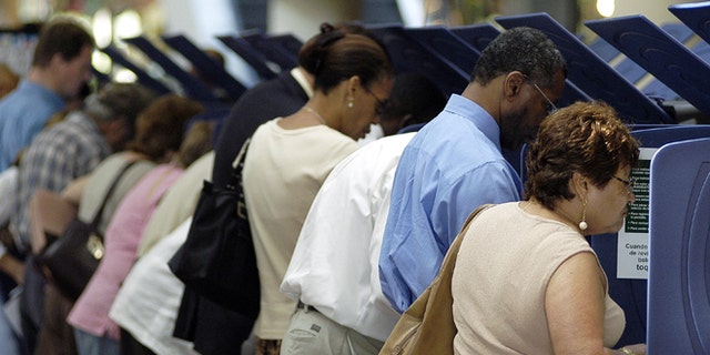 MIAMI - OCTOBER 21: Hispanic voters go to the polls for early voting at the Miami-Dade Government Center on October 21, 2004 in Miami, Florida. Early voting began this week in Florida and is under heavy scrutiny after the debacle in the 2000 election. (Photo by G. De Cardenas/Getty Images)