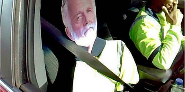 This Monday, March 23, 2015 photo by Washington State Patrol Trooper Tony Brock shows a cardboard cutout of the "The Most Interesting Man In The World," otherwise known as actor Jonathan Goldsmith, of Dos Equis beer TV commercial fame, strapped to the passenter seat of a driver who tried to use the image to qualify to drive the carpool lane on Interstate 5 near Fife, Wash. The trooper says it's by far the best carpool scam he's seen, but it didn't work. Both were chuckling as the driver, whose name wasn't released, said "He's my best friend." The Most Interesting Man was not confiscated, but the driver was told not to use him again. The State Patrol tweeted the photo, saying: "I don't always violate the HOV lane law ... but when I do, I get a $124 ticket." (AP Photo/Washington State Patrol, Trooper Tony Brock)
