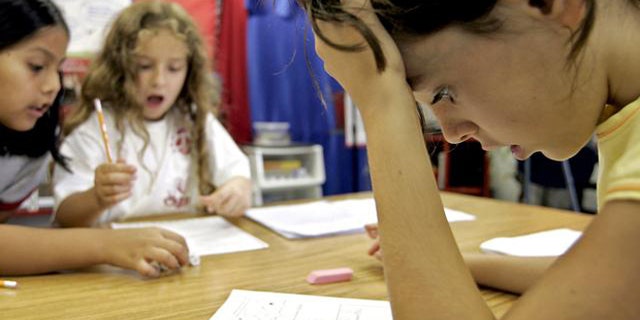 Third grade student Georgia Allin, right, participates in a math exercise with classmates Maria Ortiz-Pozo, left, and Erin Rieman, center, at Barcroft Elementary School in Arlington, Va., Tuesday, Aug. 16, 2005, outside Washington. People in this country have a love-hate relationship with mathematics, a favorite subject for some but just a bad memory for many others, especially women, according to an AP-AOL poll. (AP Photo/Charles Dharapak)