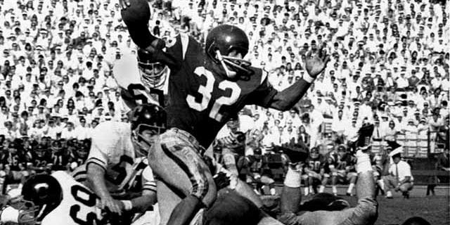 Nov. 9, 1968: FILE - Southern California's O.J. Simpson tries to break a California tackle as he picks up five yards at the Los Angeles Memorial Coliseum. Los Angeles police said in a statement Tuesday they've recovered a Heisman Trophy honoring O.J. Simpson more than 20 years after it was stolen from the University of Southern California. (AP Photo/File)