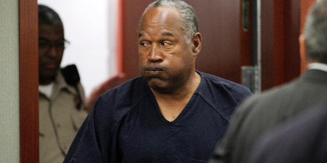 O.J. Simpson returns to the courtroom after a lunch break during the fifth day of an evidentiary hearing in Clark County District Court in Las Vegas, Nevada  May 17, 2013. Simpson, who is currently serving a nine-to-33-year sentence in state prison as a result of his October 2008 conviction for armed robbery and kidnapping charges, is using a writ of habeas corpus to seek a new trial, claiming he had such bad representation that his conviction should be reversed.  REUTERS/Steve Marcus (UNITED STATES  - Tags: CRIME LAW SPORT ENTERTAINMENT)   - RTXZR2N