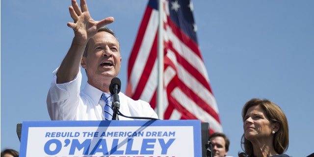 Former Maryland Gov. Martin O'Malley speaks during an event to announce that he is entering the Democratic presidential race, on Saturday, May 30, 2015, in Baltimore, as his wife Katie, right, looks on. O'Malley joined the Democratic presidential race with a longshot challenge to Hillary Rodham Clinton for the 2016 nomination. "I'm running for you," he told a crowd of about 1,000 people at Federal Hill Park in Baltimore, where he served as mayor before two terms as governor. (AP Photo/Evan Vucci)