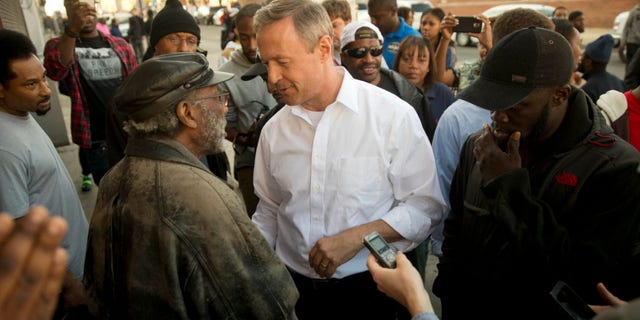 April 28, 2015: Former Maryland Gov. Martin O'Malley, center, meets with residents in Baltimore, Md.