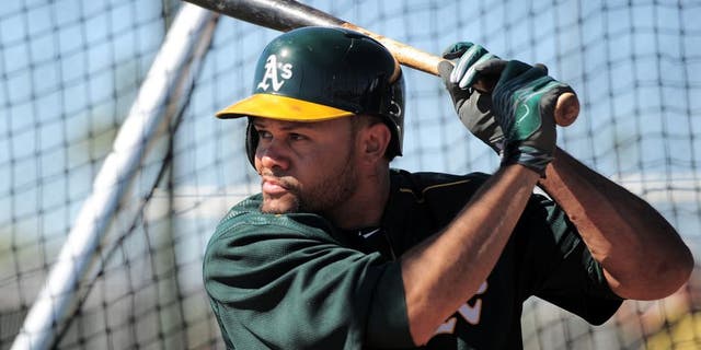 Feb 25, 2015; Mesa, AZ, USA; Oakland Athletics center fielder Coco Crisp (4) bats during a workout at Fitch Park. Mandatory Credit: Joe Camporeale-USA TODAY Sports