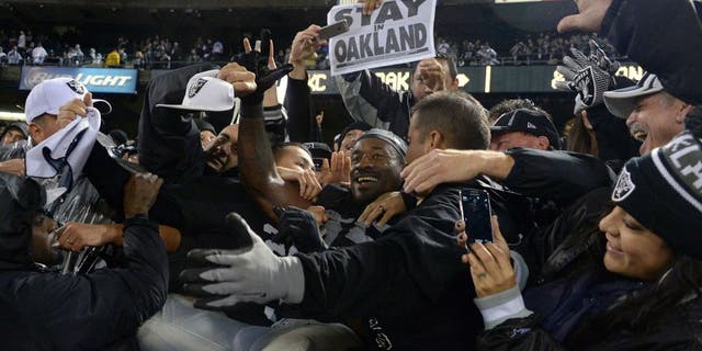Nov 20, 2014; Oakland, CA, USA; Oakland Raiders lineabcker Sio Moore (55) celebrates with fans after the game against the Kansas City Chiefs at O.co Coliseum. The Raiders defeated the Chiefs 24-20. Mandatory Credit: Kirby Lee-USA TODAY Sports