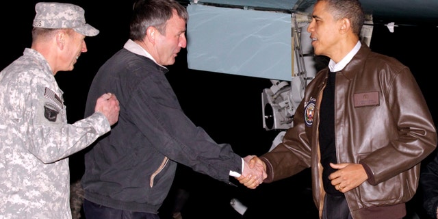 Dec. 3: Obama is greeted by Gen. David Petraeus, left, and US Ambassador to Afghanistan Karl W. Elkenberry, center, after stepping off Air Force One during an unannounced visit to Bagram Air Field in Afghanistan.