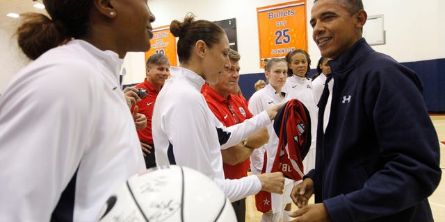 July 16, 2012: President Barack Obama, right, meets with Team USA's Tamika Catchings, left, and Diana Taurasi, center, and other members of the Olympic women's basketball following their exhibition game against Brazil in Washington.