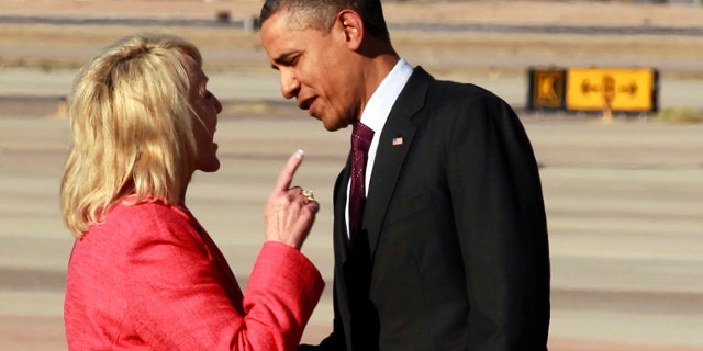 Jan. 25, 2012: Arizona Gov. Jan Brewer points at President Obama after he arrived at Phoenix-Mesa Gateway Airport.