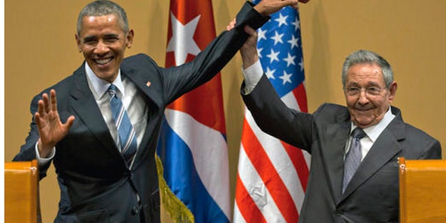 FILE - In this March 21, 2016 file photo, Cuban President Raul Castro, right, lifts up the arm of President Barack Obama at the conclusion of their joint news conference at the Palace of the Revolution, in Havana, Cuba. Donald Trumps pledge to undo Obamas detente with Cuba is provoking widespread anxiety among ordinary Cubans, who were paying little attention to the U.S. presidential campaign until now. (AP Photo/Ramon Espinosa, File)