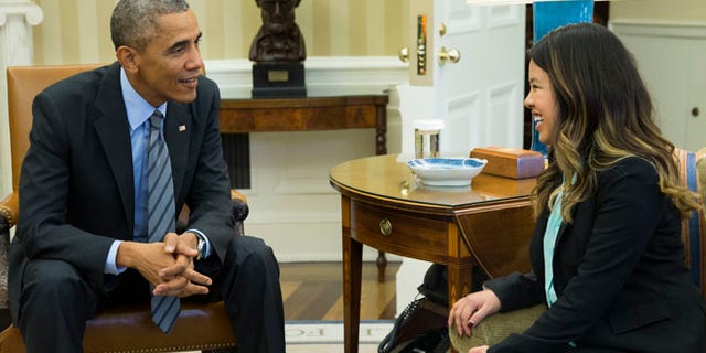 In this Friday, Oct. 24 photo, President Barack Obama meets with Ebola survivor Nina Pham in the Oval Office of the White House in Washington.