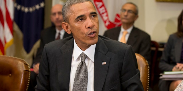 In this Monday, Oct. 6, 2014 photo, President Barack Obama meets with members of his national security team and senior staff to receive an update on the Ebola outbreak in West Africa in the Roosevelt Room of the White House in Washington.
