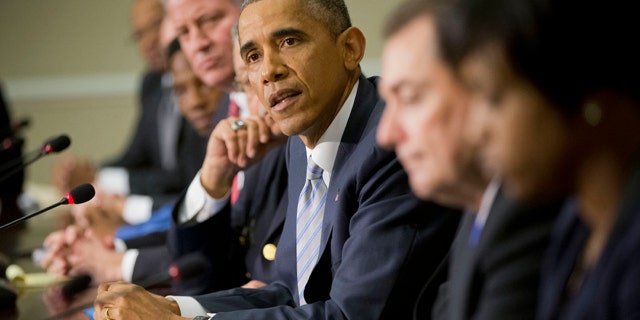 December 1, 2014: President Barack Obama, center, speaks during his meeting with elected officials, law enforcement officials and community and faith leaders in the Old Executive Office Building on the White House Complex in Washington. (AP Photo/Pablo Martinez Monsivais)