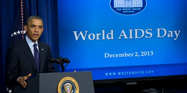 President Barack Obama gestures while speaking at a world AIDS Day event, Monday, Dec. 2, 2013, in the South Court Auditorium on the White House complex in Washington. (AP Photo/ Evan Vucci)