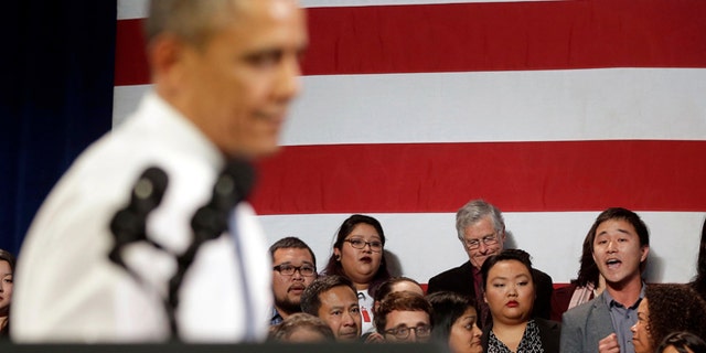 In this Nov. 25, 2013, photo, President Barack Obama, left, stops his speech and turns around in response to an unidentified man, right, who heckled him about anti-deportation policies, at the Betty Ann Ong Chinese Recreation Center in San Francisco. Obama stopped his speech about immigration reform to let this man, who was located directly behind Obama, speak and would respond to his questions. Advocates are frustrated with the failure of House Republicans to tackle immigration. Increasingly, theyâre focus is on President Barack Obama. The outside groups are demanding that Obama use his powers as chief executive to stop deportations or provide some relief to many of the 11 million immigrants living here illegally.  (AP Photo/Pablo Martinez Monsivais, File)