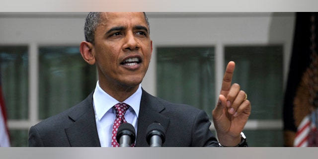 President Barack Obama responds as he is interrupted while announcing that his administration will stop deporting and begin granting work permits to younger illegal immigrants who came to the U.S. as children and have since led law-abiding lives, Friday, June 15, 2012, during a statement in the Rose Garden of the White House in Washington. (AP Photo/Susan Walsh)