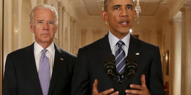 President Barack Obama, standing with Vice President Joe Biden, delivers remarks in the East Room of the White House in Washington, Tuesday, July 14, 2015, after an Iran nuclear deal is reached. After 18 days of intense and often fractious negotiation, diplomats Tuesday declared that world powers and Iran had struck a landmark deal to curb Iran's nuclear program in exchange for billions of dollars in relief from international sanctions. (AP Photo/Andrew Harnik, Pool)