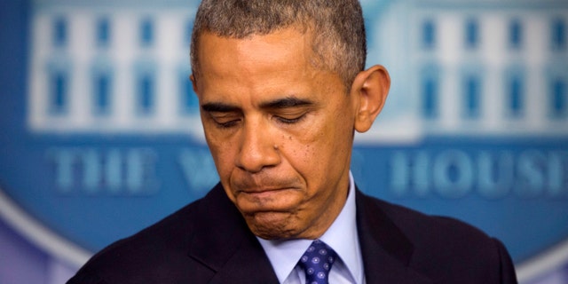 FILE - This June 19, 2014, file photo shows President Barack Obama pausing as he talks will about the situation in Iraq at the White House in Washington. Obama acknowledged the risks of mission creep when he outlined plans to help Iraq combat the Islamic insurgency that has made gains with lighting speed, but he pledged that the U.S. will not be "dragged back" into a lengthy conflict or become ensnarled in "mission creep." The deployments mark a sharp shift for a president who oversaw the full withdrawal of American forces from Iraq in late 2011 after Washington and Baghdad failed to reach an agreement to keep a few thousand troops in place. (AP Photo/Pablo Martinez Monsivais, File)