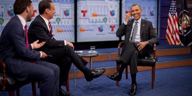 President Obama with television hosts Jose Diaz Balart and Enrique Acevedo, in Washington, Thursday, March 6, 2014.