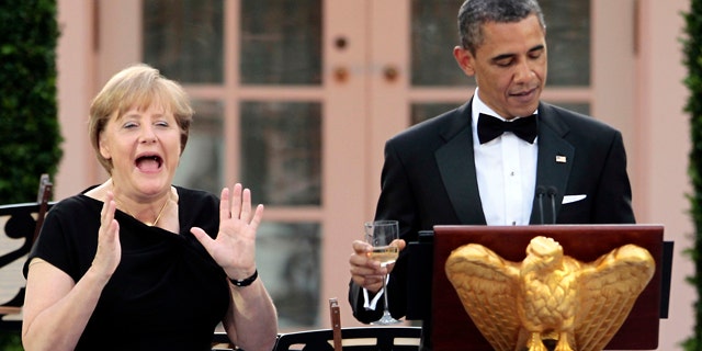 June 7: German Chancellor Angela Merkel, left, reacts as President Obama remembers to share a toast in her honor at a State Dinner in the Rose Garden of the White House in Washington.