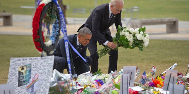 President Barack Obama and Vice President Joe Biden place flowers down during their visit to a memorial to the victims of the Pulse nightclub shooting, Thursday, June 16, 2016 in Orlando, Fla. Offering sympathy but no easy answers, Obama came to Orlando to try to console those mourning the deadliest shooting in modern U.S history. (AP Photo/Pablo Martinez Monsivais)