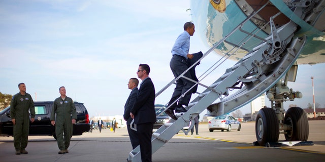 U.S. President Barack Obama boards Air Force One at Ramstein Air Base, Saturday, March 29, 2014, in Germany. Air Force One was making a scheduled refueling stop in Germany and he was using the opportunity to meet with US members of the military. Obama is returning back to Washington after a week long trip aboard to Europe and Saudi Arabia. (AP Photo/Pablo Martinez Monsivais)