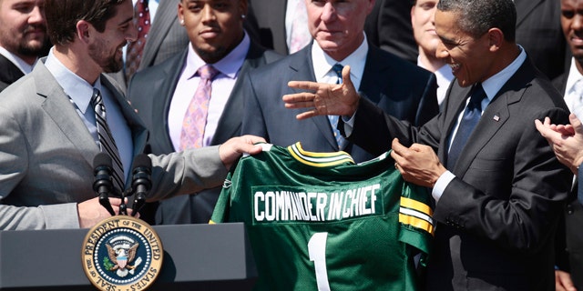 Aug. 12, 2011: President Obama is presented a Green Bay Packers football jersey by quarterback Aaron Rodgers, left, during a ceremony honoring the Super Bowl XLV Champion Green Bay Packers.