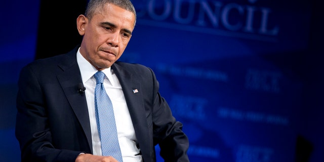 President Barack Obama pauses as he listens to a question about corporate tax reform during the Wall Street Journal CEO Council annual meeting in Washington, Tuesday, Nov. 19, 2013. Obama also discussed the economy, the problems with the new health care law roll out, immigration reform, and negotiations with Iran over their nuclear program. (AP Photo/ Evan Vucci)