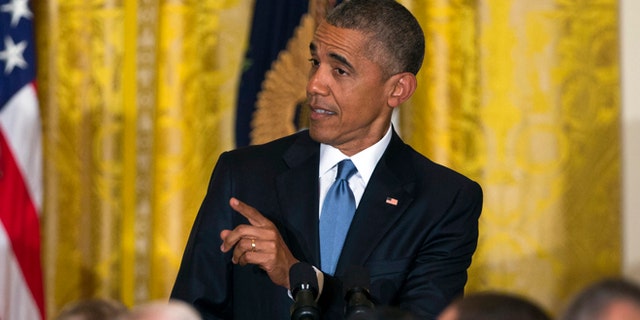 President Barack Obama responds to a heckler as he speaks during a reception to celebrate LGBT Pride Month in the East Room of the White House, on Wednesday, June 24, 2015, in Washington. (AP Photo/Evan Vucci)