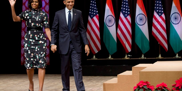 Jan. 27, 2015: President Barack Obama walks from the stage with first lady Michelle Obama after his speech at the Siri Fort Auditorium in New Delhi, India. (AP Photo/Carolyn Kaster)