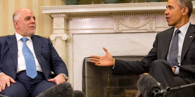 President Barack Obama speaks during his meeting with Iraqi Prime Minister Haider Al-Abadi in the Oval Office of the White House in Washington, Tuesday, April 14, 2015. The Prime Minister is visiting to discuss U.S.-Iraq policy and the fight against the IS group. (AP Photo/Jacquelyn Martin)