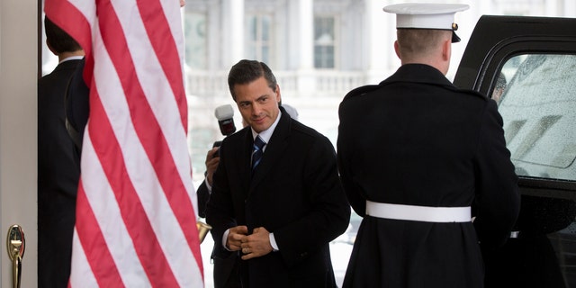 Mexico's President Enrique Pena Nieto at the White House in Washington, Tuesday, Jan. 6, 2015, for meetings with President Barack Obama. Obama is looking to his southern neighbor for help implementing the changing policies on immigration and Cuba. (AP Photo/Carolyn Kaster)